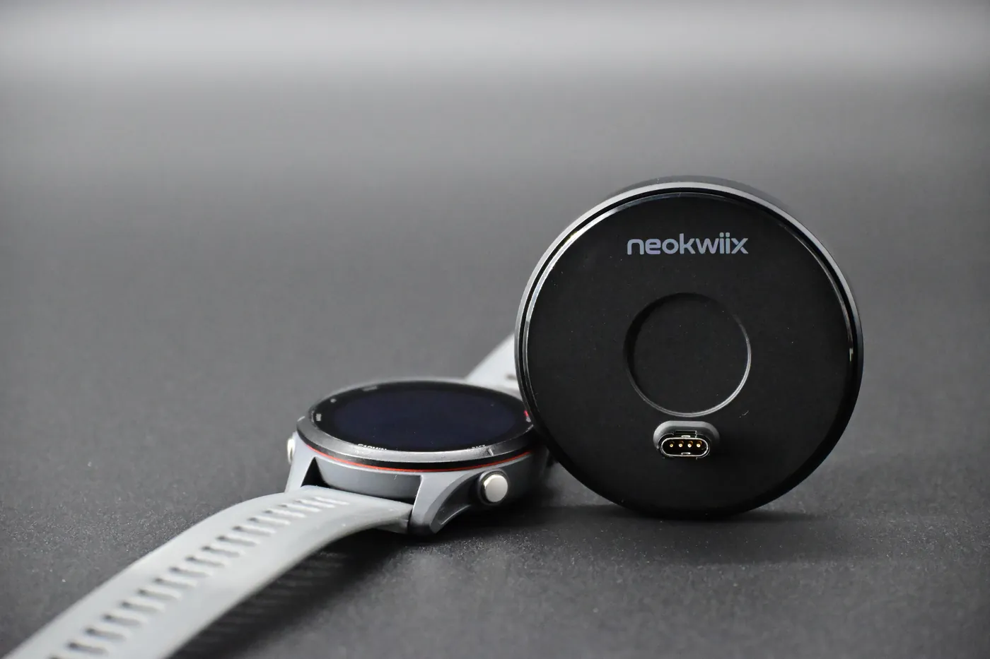 The NEOKWIIX adapter next to a Garmin watch