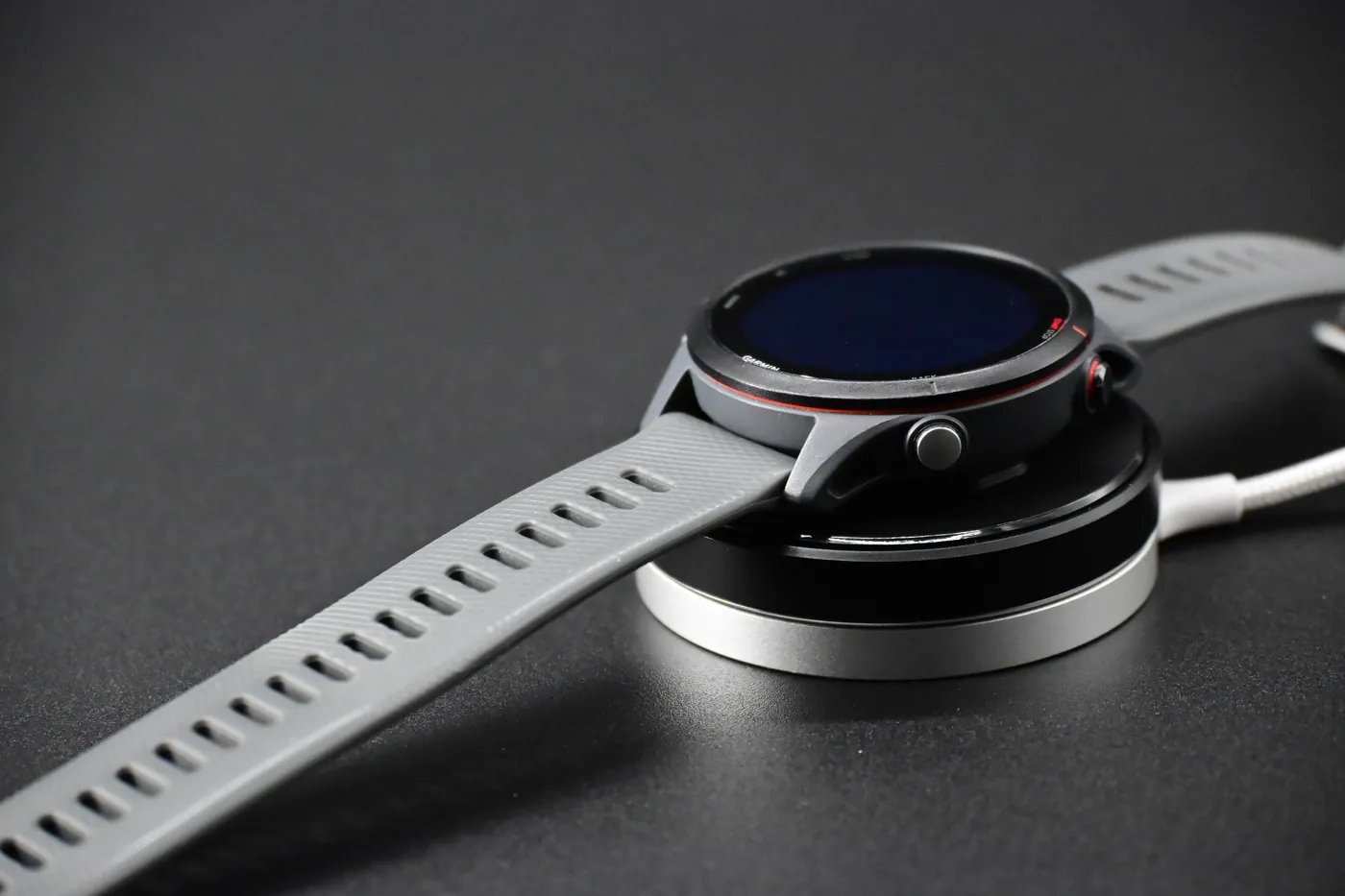 Adapter snapped onto a magnetic wireless charger with a Garmin watch attached